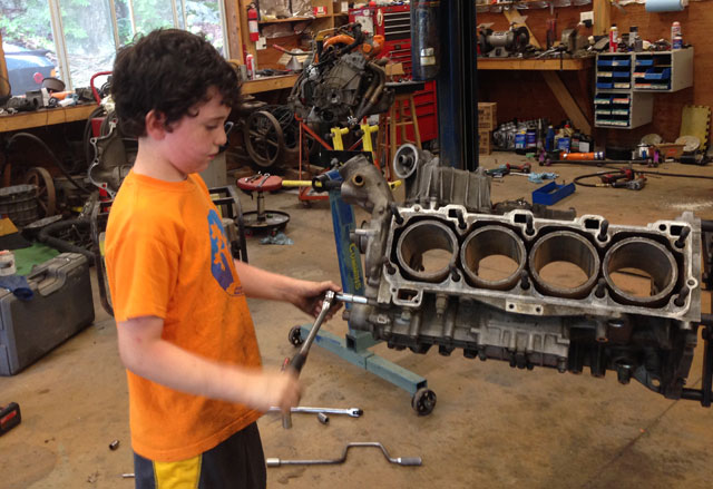Young Hack Racer taking apart an engine